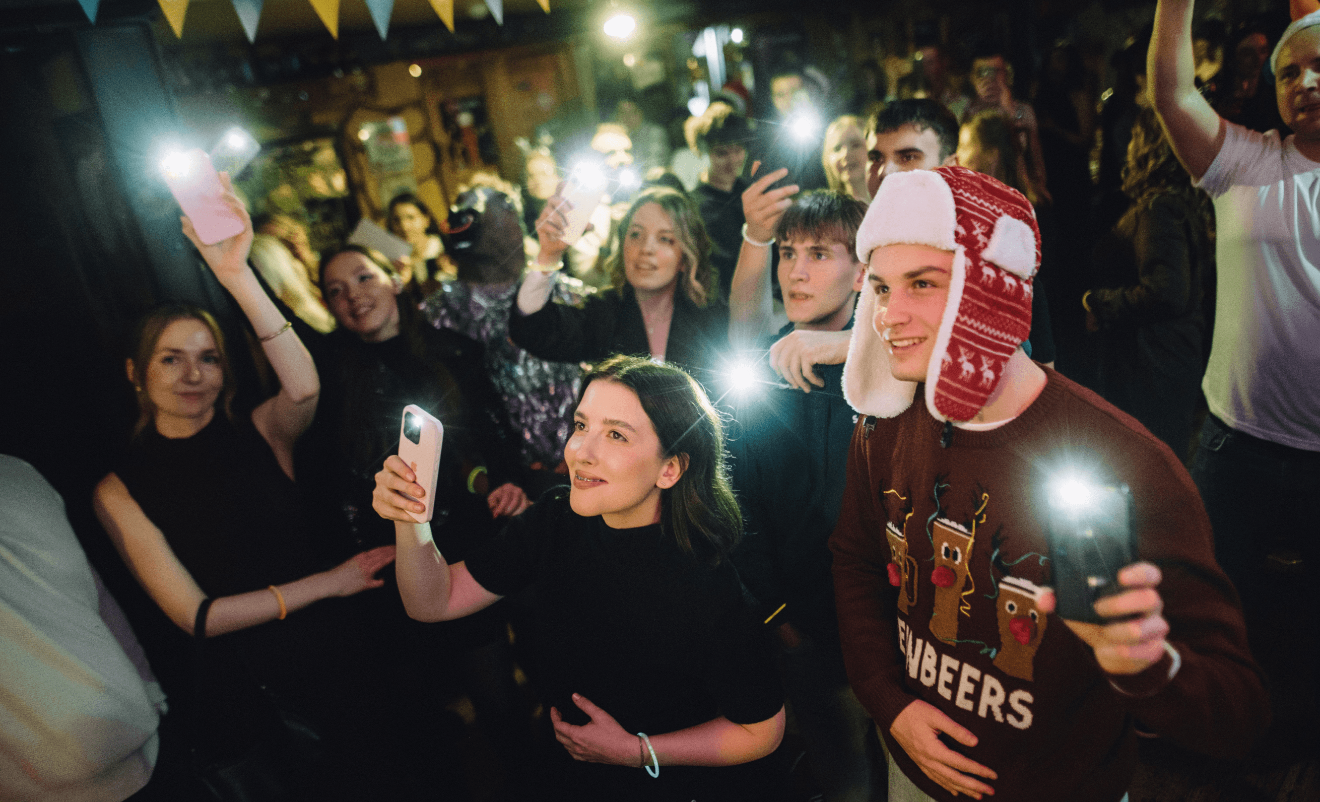 Modsen employees at a corporate party with flashlights Modsen employees at a corporate party with flashlights